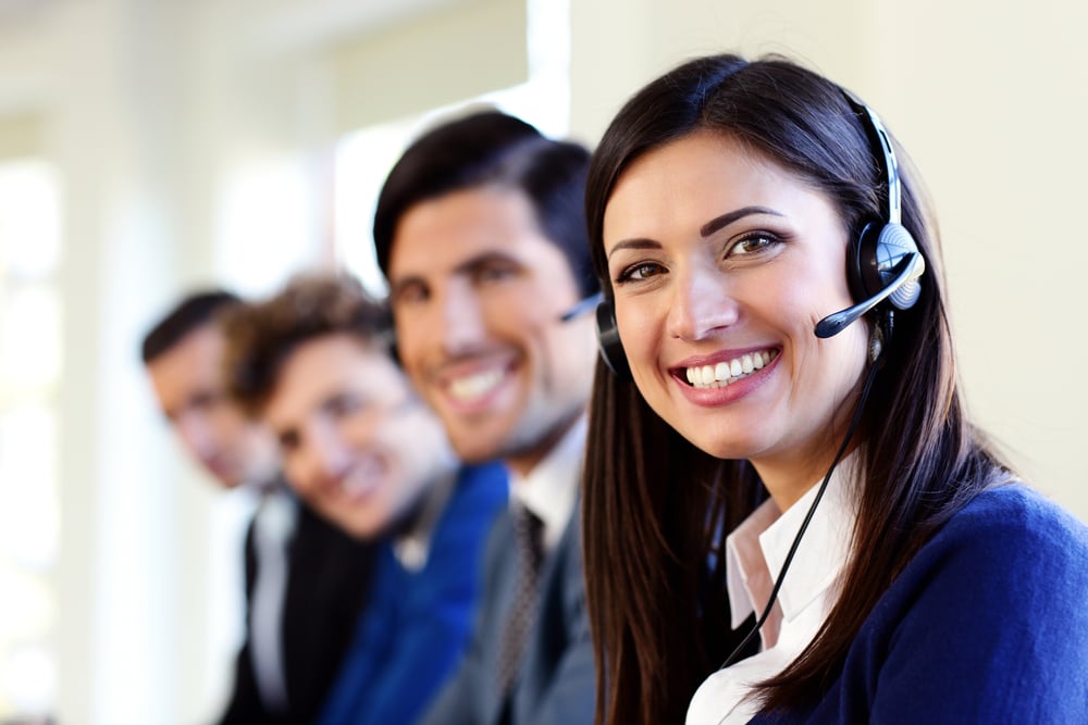 Cheerful young businesspeople and colleagues in a call center office Cheerful young businesspeople and colleagues in a call center office