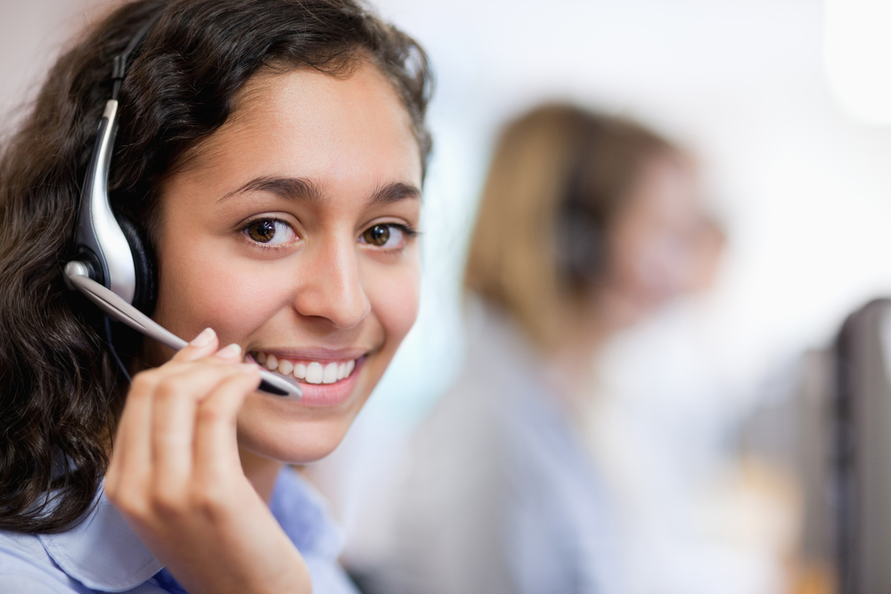 Close up of a smiling customer assistant wearing a headset Close up of a smiling customer assistant wearing a headset